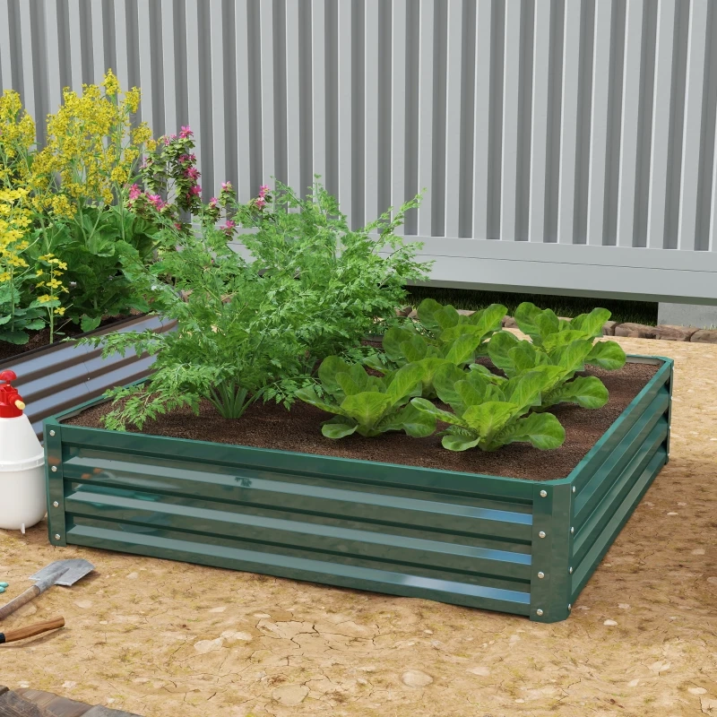 Backyard raised garden bed with vegetables beside wooden patio and outdoor dining area.