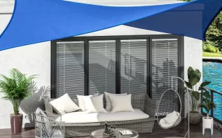 Tan shade sail providing backyard sun protection over grass and outdoor seating.