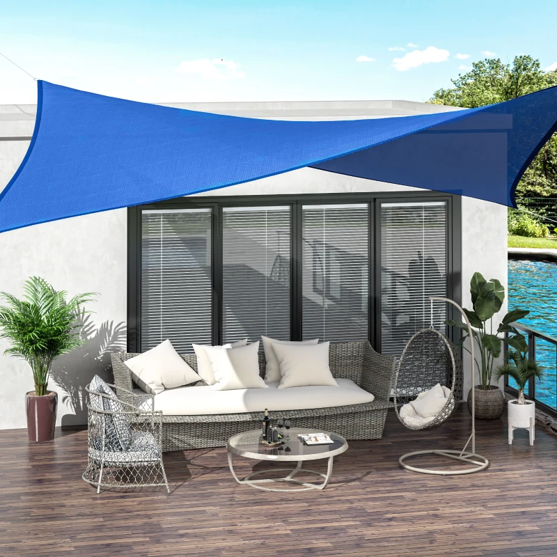 Tan shade sail providing backyard sun protection over grass and outdoor seating.