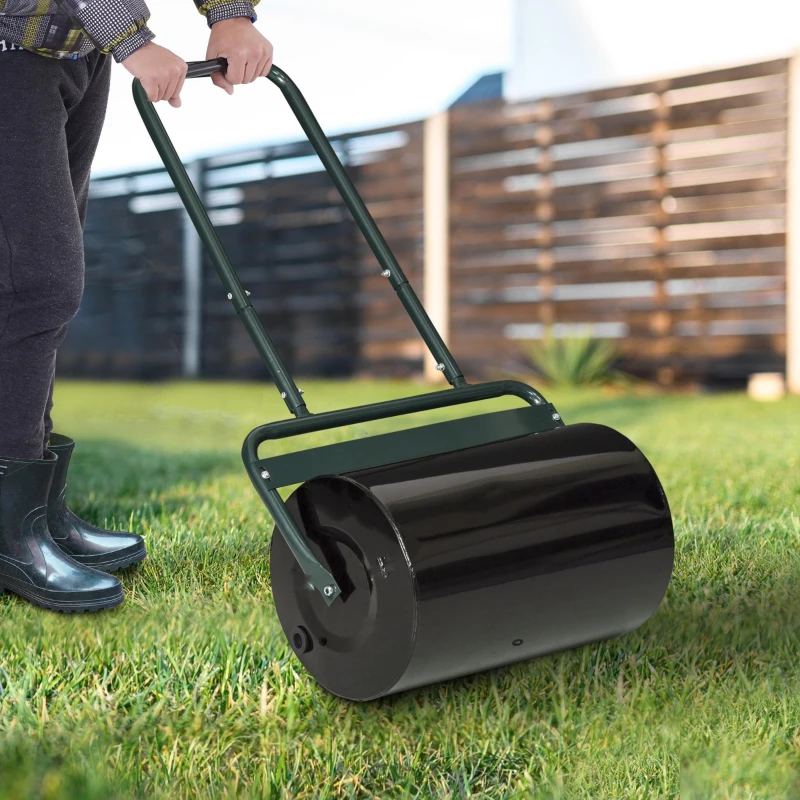 Rolling a lawn roller over grass for soil compaction.