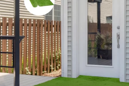 Fully installed artificial grass on patio with circular inset showing rolled synthetic turf sample.