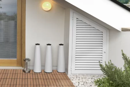 Installing interlocking deck tiles by clicking them into place on a flat surface