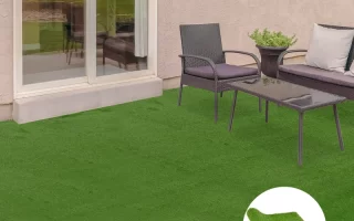 Clean artificial turf patio with glass table, black chairs, and plant pot near sliding door.