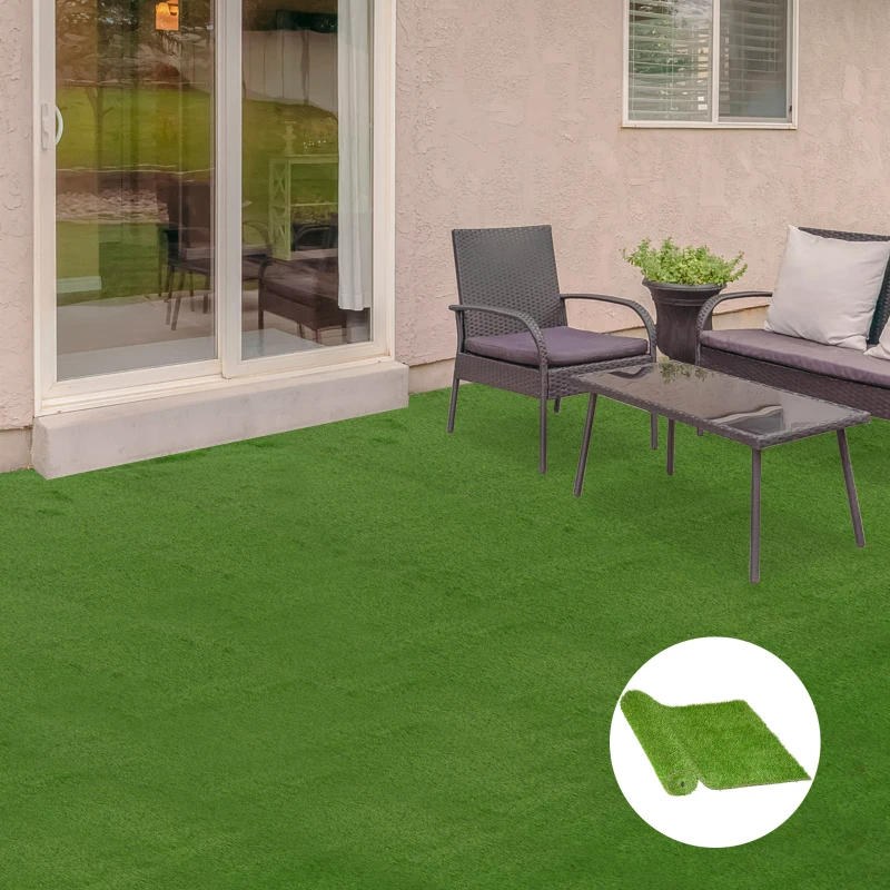 Clean artificial turf patio with glass table, black chairs, and plant pot near sliding door.