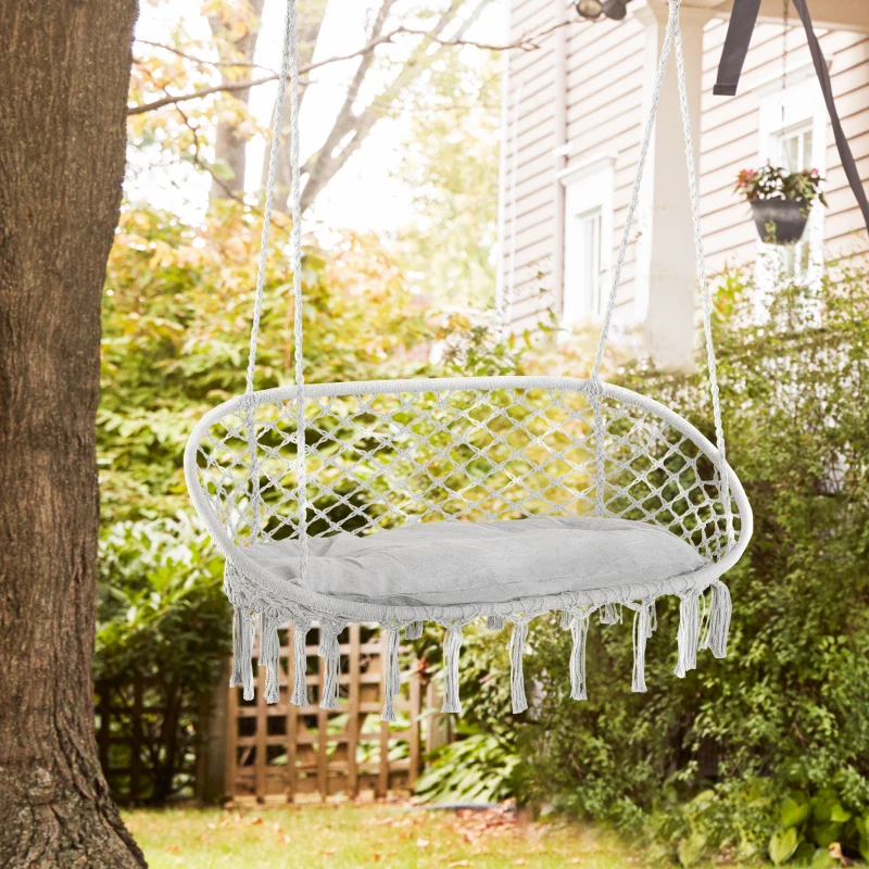 Bohemian-style two-person hammock chair hanging in a cozy indoor living space.