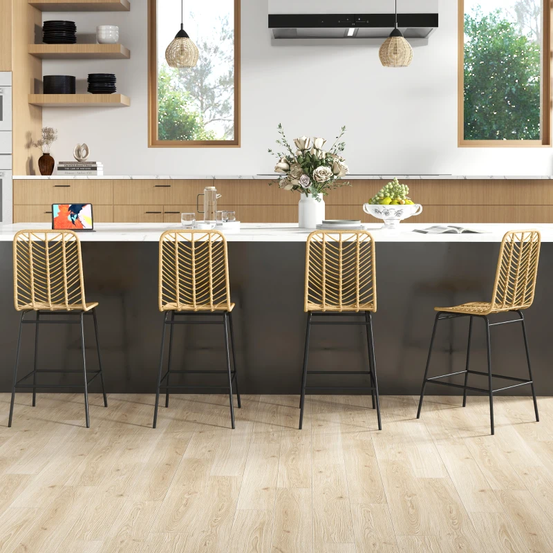 Four rattan bar stools at a white kitchen island with pendant lights and elegant home decor.