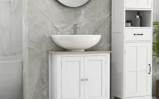 White bathroom vanity with round mirror and light grey marble walls in a modern setting.
