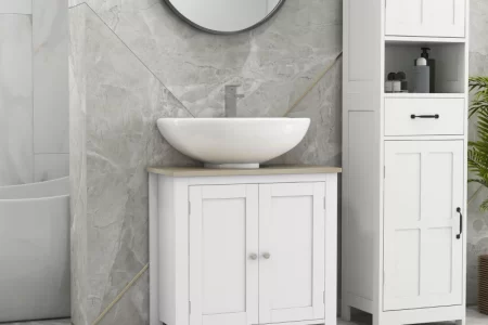 White bathroom vanity with round mirror and light grey marble walls in a modern setting.