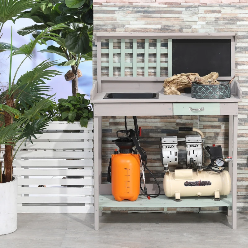 Outdoor potting station with potted plants, watering cans, and decorative gardening tools.