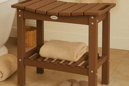 Teak shower bench with folded towels and slippers beside a bathtub in a tiled bathroom.