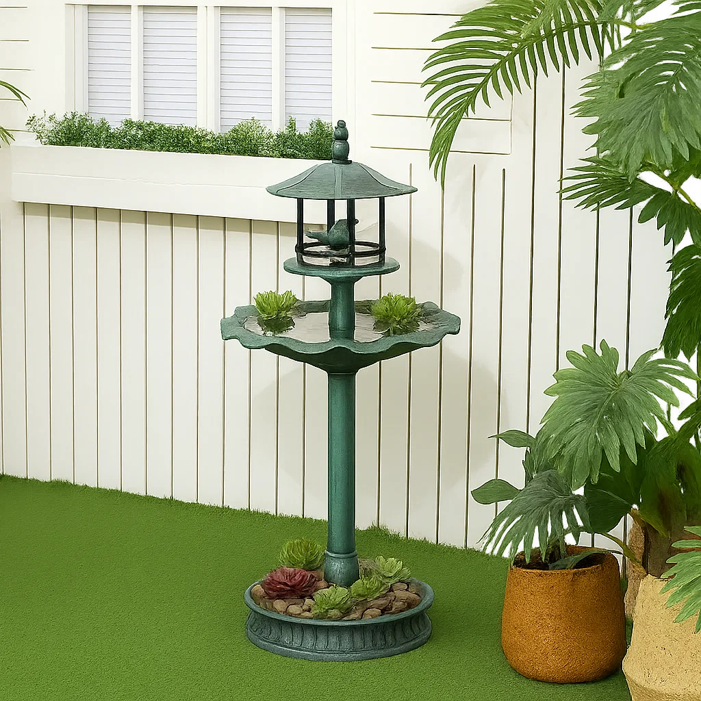 Bird bath adorned with stones and small plants for a miniature rock garden effect.