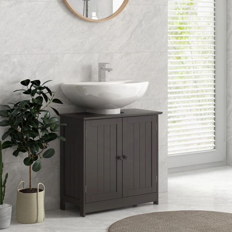 Dark bathroom vanity with round mirror and indoor plant against marble-tiled wall and floor.