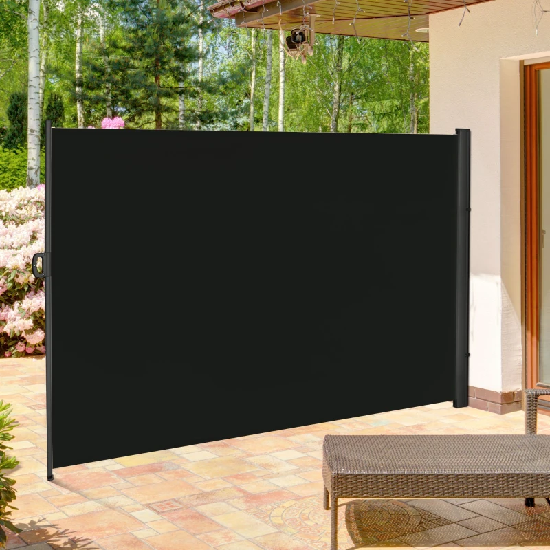 Black retractable awning extended in a garden area for shading and privacy.
