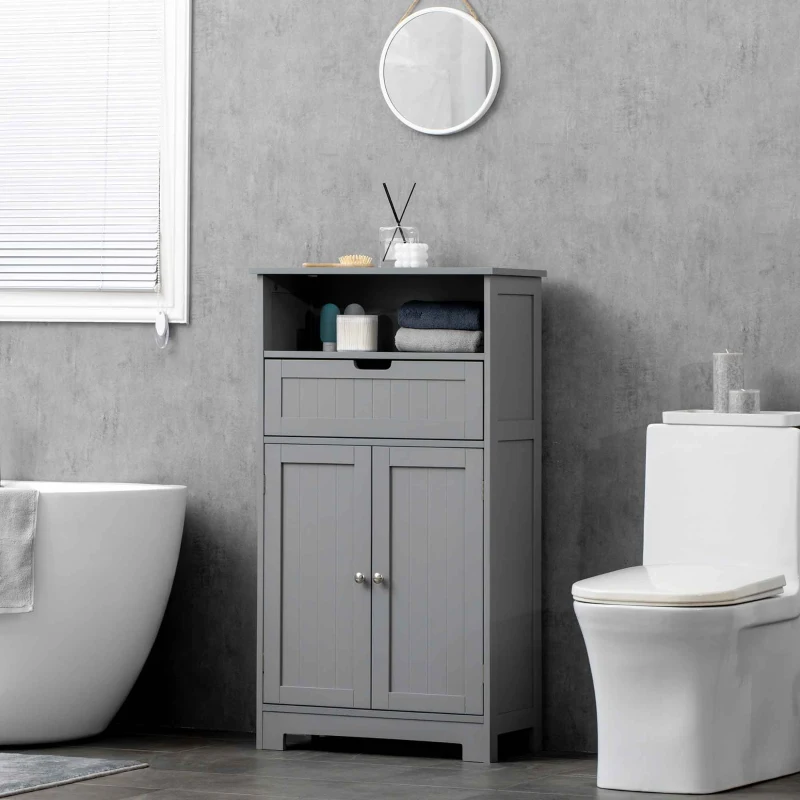 Tall grey bathroom cabinet beside bathtub and toilet, holding towels and toiletries for storage.