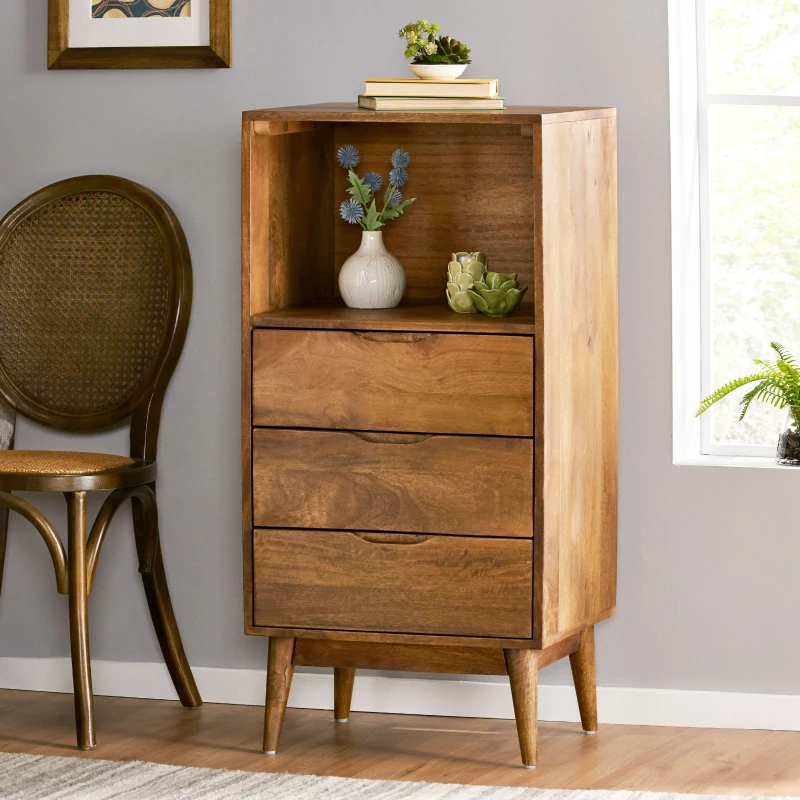 Brown end table with books and plant, placed beside a bed.