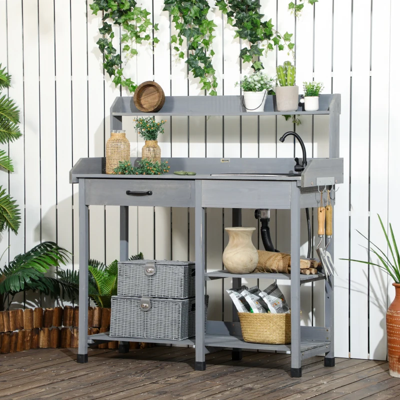 Outdoor potting bench with built-in sink, faucet, and storage shelves.