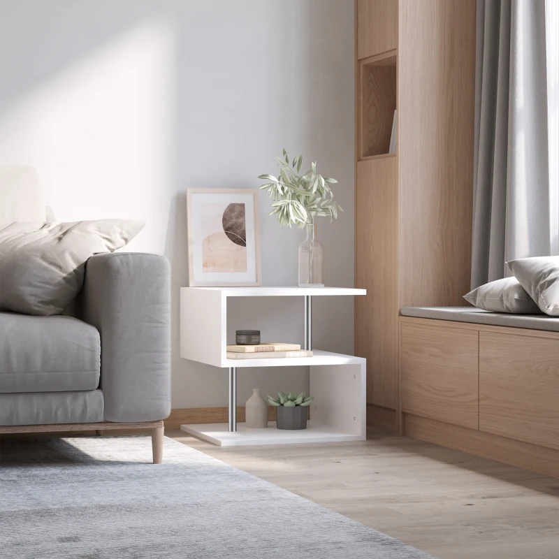 Minimalist white end table with books, vase, art print, and greenery near window bench seating
