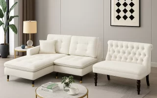 White sectional sofa and tufted armless loveseat in a modern living room with gold accents.