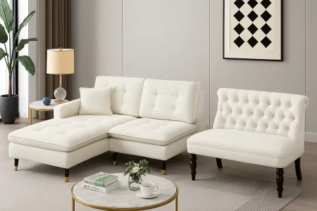 White sectional sofa and tufted armless loveseat in a modern living room with gold accents.