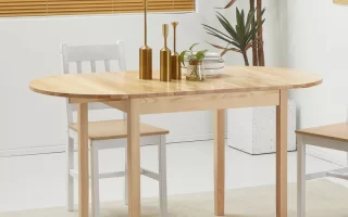 Minimalist wooden dining table with chairs and golden decor in a clean, well-lit dining room.
