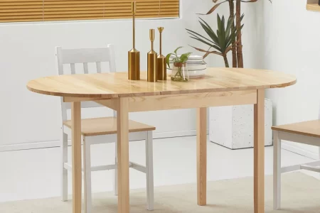 Minimalist wooden dining table with chairs and golden decor in a clean, well-lit dining room.