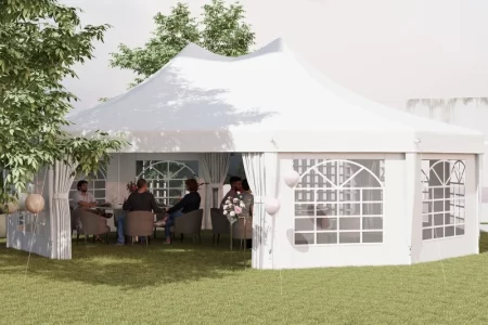 Group seated inside a large white outdoor canopy tent set up for a garden event