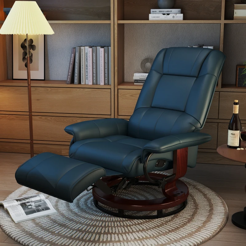 Blue leather recliner with wooden base and extended footrest in a cozy reading corner.