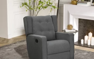 Grey tufted recliner placed in a bright room with a fireplace and indoor plant decor.