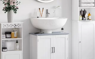 Modern bathroom with round mirror, white vanity, floral decor, and organized open shelves.