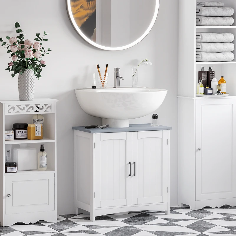 Modern bathroom with round mirror, white vanity, floral decor, and organized open shelves.
