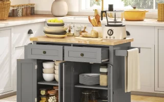 Grey kitchen island with open storage filled with plates, bowls, and glass jars.