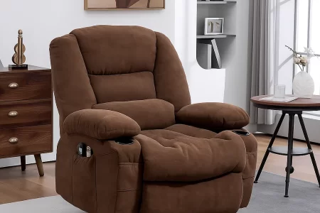 Brown plush recliner chair with pillow placed in a cozy and sunlit living room.
