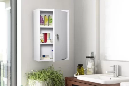 White wall cabinet installed above sink in a modern bathroom with indoor plants nearby.