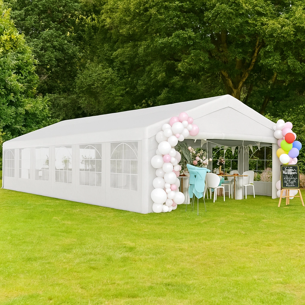 White outdoor canopy tent with balloon decor set up for a party in a grassy area.