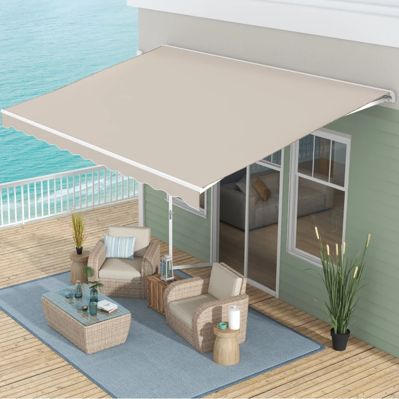 Beige retractable awning installed over coastal deck with wicker patio furniture and ocean view.