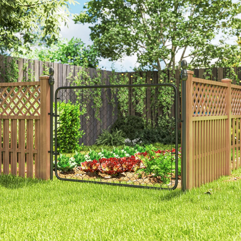 Installed garden gate with metal frame and wire mesh beside wooden lattice fencing.