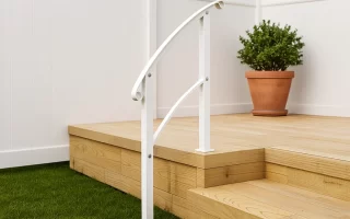 Painted white outdoor stair railing in sunlight.