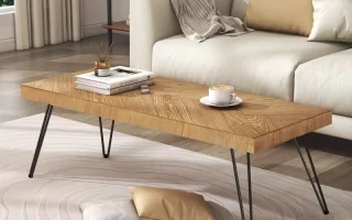 Finished wood coffee table styled with decor in a modern living room after a full refinishing process.