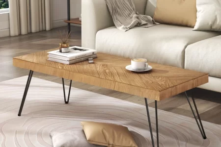 Finished wood coffee table styled with decor in a modern living room after a full refinishing process.