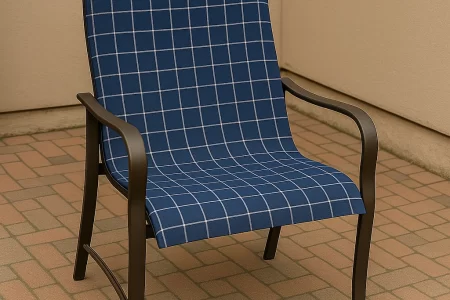 Reupholstered patio chair with new blue checkered fabric in an outdoor setting