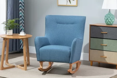 Finished blue fabric rocking chair placed on a rug beside a table and dresser