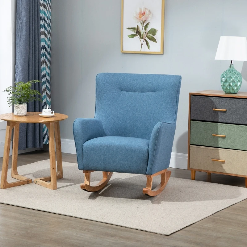 Finished blue fabric rocking chair placed on a rug beside a table and dresser