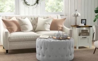 Velvet tufted ottoman with copper tray, serving tea and book, replacing a traditional coffee table.