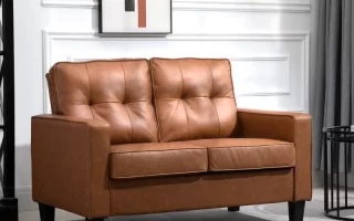Brown faux leather loveseat with button-tufted cushions in a bright, stylish living room.