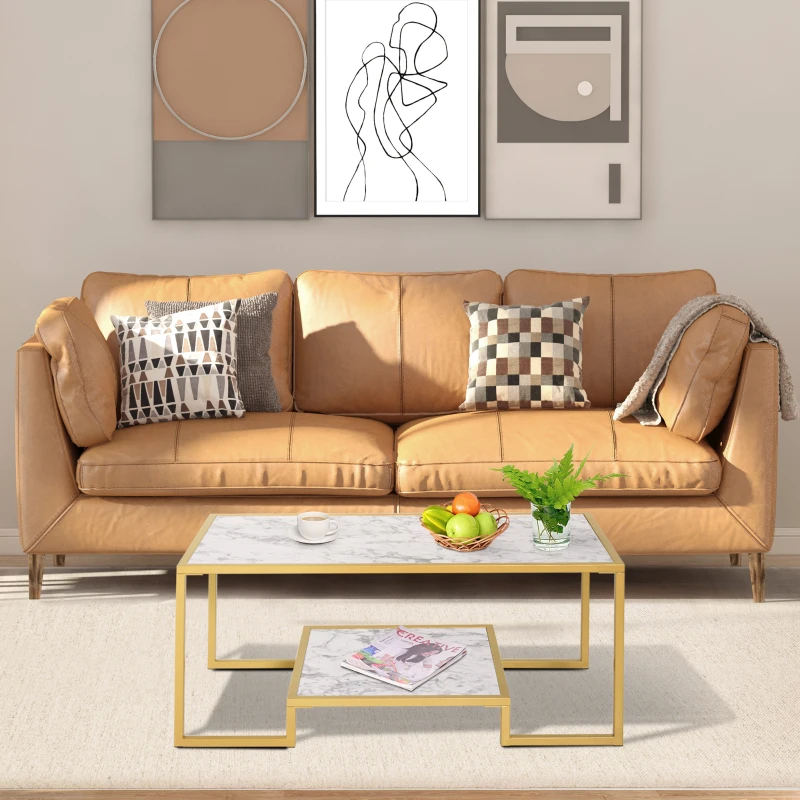 Sleek white and black coffee table styled with books and flowers in a modern grey-toned space.
