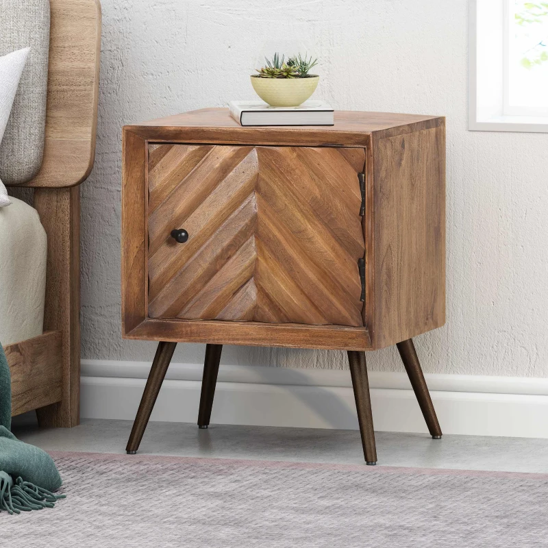 Mid-century modern side table made from mango wood featuring tapered legs and a sleek drawer.