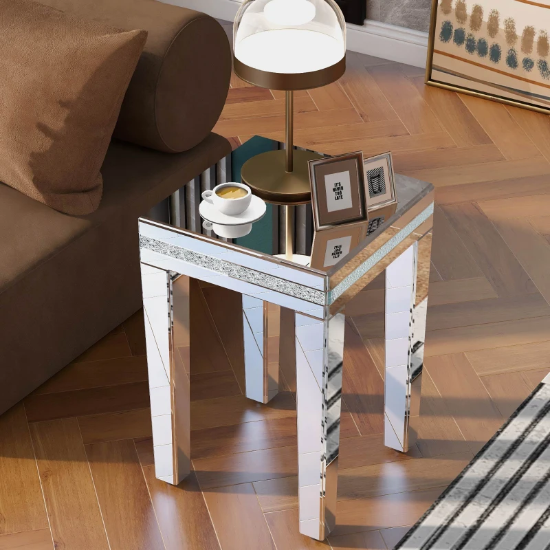 Elegant mirrored side table with glass surfaces reflecting light in a glamorous interior.