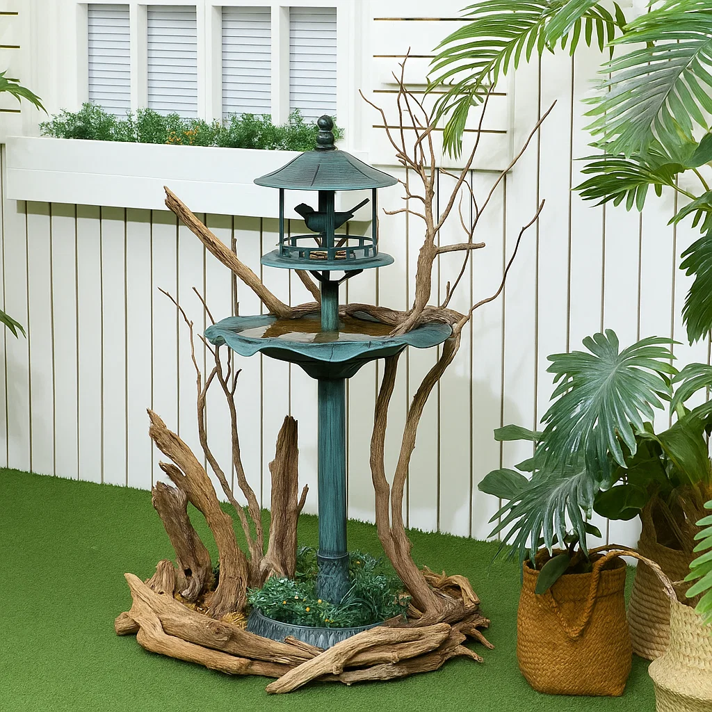 Bird bath embellished with natural driftwood and branches for an organic outdoor look.