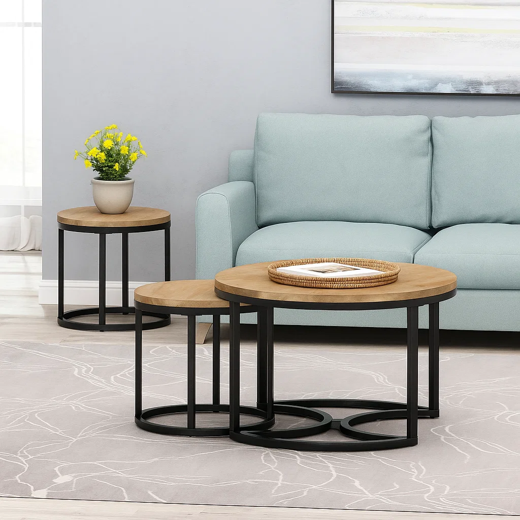 Round coffee table with a woven tray and neutral books placed beside a blue sofa and matching side tables.
