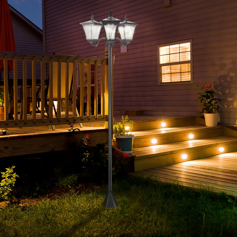 Three-head solar lamp post lighting up a front yard with a vintage feel.